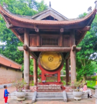A "superman" boy eyes this temple gong